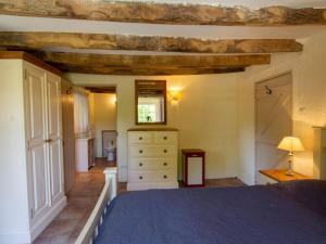 a bedroom with a blue bed and a dresser at Maison de charme avec jardin clos et Wifi au cœur du Périgord Noir - FR-1-616-401 in Saint-Pompont