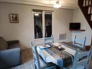 a room with a table and chairs and a couch at Chalet rustique au cœur du Périgord Noir avec terrasse et confort inclus - FR-1-616-397 in Saint-Pompont