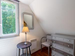 a bedroom with a table with a lamp and a chair at Chalet rustique au cœur du Périgord Noir avec terrasse et confort inclus - FR-1-616-397 in Saint-Pompont +3 photos