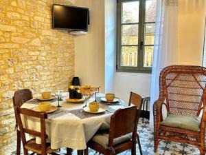 a dining room with a table and chairs at Maison climatisée avec jardin au cœur de Sarlat - FR-1-616-399 in Sarlat-la-Canéda
