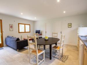 a kitchen and dining room with a table and chairs at Chalet bois intime avec Wifi, piscine partagée, à 1 km de St Pompont - FR-1-616-429 in Saint-Pompont +5 photos
