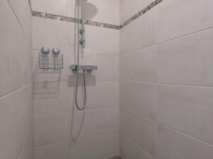 a white bathroom with a shower with a hose at Studio moderne avec WiFi et parking à Baignes - FR-1-653-270 in Baignes-Sainte-Radegonde +8 photos