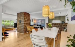 a dining room and living room with a white table and chairs at Three-Bedroom Holiday Home In Ebeltoft in Ebeltoft