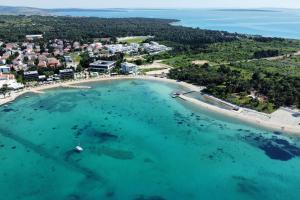 an aerial view of a beach and the ocean at Apartments with parking space Novalja, Pag - 9419 in Novalja