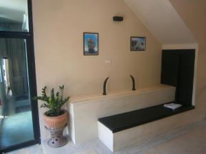a bench in a room with a fireplace at Infinity Boutique Hotel Kata Beach in Ban Kata +37 photos