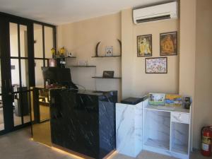 a room with a desk with a glass counter top at Infinity Boutique Hotel Kata Beach in Ban Kata