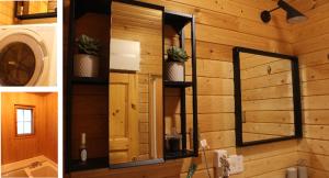 a mirror on a wall in a bathroom at Second House sch-sch(スクスク） in Kita-karuizawa