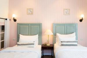 Postel nebo postele na pokoji v ubytování Nai Suan Bed and Breakfast