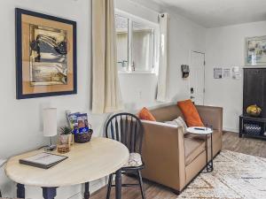 a living room with a couch and a table at Quaint Monument Retreat studio in Grand Junction