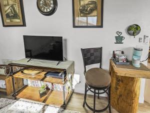 a desk with a television and a chair in a room at Quaint Monument Retreat studio in Grand Junction +25 photos