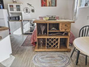 a kitchen with a table and a wooden cabinet at Quaint Monument Retreat studio in Grand Junction