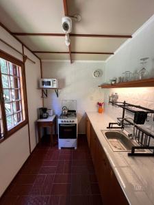 a small kitchen with a stove and a sink at Mauruuru in La Pedrera
