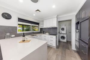 a kitchen with white cabinets and a white counter top at Pet Friendly home in Maroochydore in Maroochydore