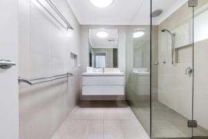 a bathroom with a glass shower and a sink at Pet Friendly home in Maroochydore in Maroochydore +8 photos