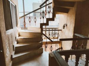 a staircase in an old building with a window at Vrinda Kunja Ashram in Vrindāvan +19 photos