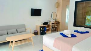 a living room with a bed and a couch at Pinky Bungalow Resort & Villa - SHA Extra Plus in Ko Lanta