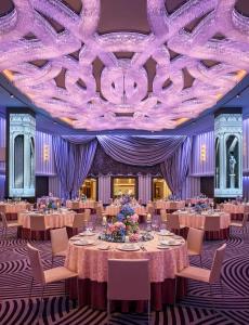 a ballroom with tables and chairs and a purple ceiling at Grand Hyatt Mumbai Hotel and Residences in Mumbai +119 photos