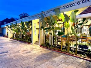 a building with a fence with plants in it at Jaladarshini Lakeside Gardens in Kollam +18 photos