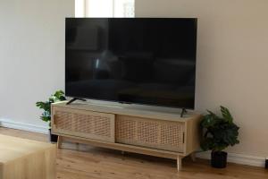a flat screen tv on a stand in a living room at Central Delight in Dubbo