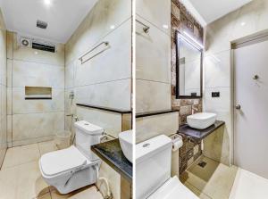 a bathroom with a toilet sink and a shower at IZI Beach Stay Mahabalipuram in Chennai