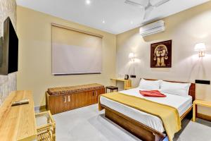 a bedroom with a bed and a projection screen at IZI Beach Stay Mahabalipuram in Chennai