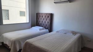 Postel nebo postele na pokoji v ubytování APt CHINCHIPE