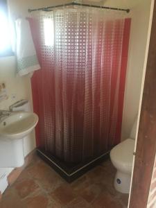 a bathroom with a sink and a toilet at Habitación Ancestral Sol Muisca in Villa de Leyva