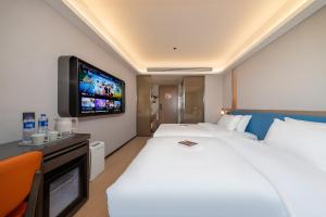Postelja oz. postelje v sobi nastanitve Warm Yes Business Hotel -Free shuttle bus during the Canton Fair