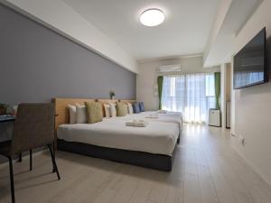a hotel room with three beds and a table at ESLEAD HOTEL Osaka Nipponbashi in Osaka +24 photos