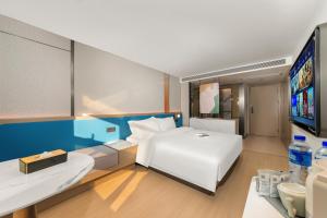 Postelja oz. postelje v sobi nastanitve Warm Yes Business Hotel -Free shuttle bus during the Canton Fair