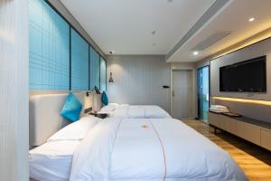Postelja oz. postelje v sobi nastanitve Warm Yes Business Hotel -Free shuttle bus during the Canton Fair