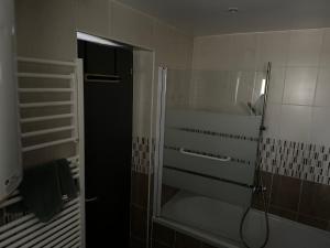 a bathroom with a shower with a glass door at Petite maison climatisée in Bonneuil-sur-Marne +20 photos