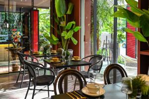 a group of tables and chairs in a restaurant at Thao Dien Village Boutique Hotel in Ho Chi Minh City