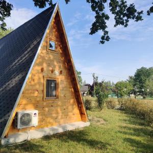 a triangular house with a window and a roof at Tipi Cheyenne des monteaux in Vivy