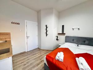 a bedroom with a red bed with white towels on it at Smart Comfort StudioN4 Private Kitchenette Bathroom to Beach 260m Marina Port old City 900m in Limassol