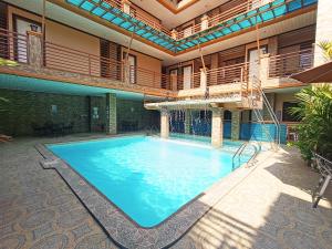 a large swimming pool in the middle of a building at R2R Bayview Inn in Coron