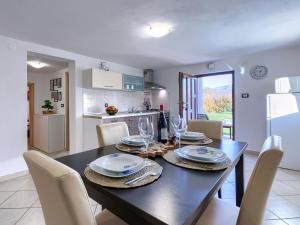 a kitchen and dining room with a table and chairs at Paola in Kršan