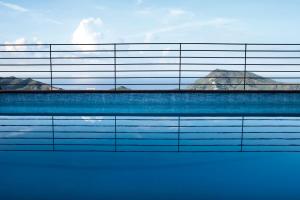 a swimming pool with a fence around it at Chincamea in Casarza Ligure