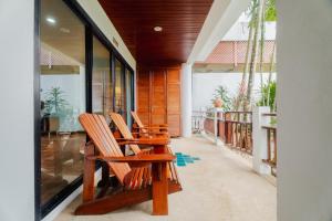 a couple of chairs sitting on a porch at The Sands 2 bedroom apartment Naiharn in Nai Harn Beach