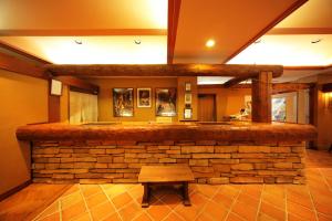 a stone bar in a room with a bench at Hotel Asyl Nara in Nara