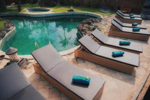 an overhead view of a swimming pool with lounge chairs at The ARIRAS Resort in Candidasa