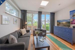 a living room with a couch and a tv at Ferienhaus am Peenestrom in Quilitz