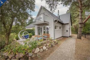 a small house with a patio in front of it at Ferienhaus am Peenestrom in Quilitz