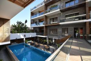 an external view of a building with a swimming pool at Ocean Park Hotel, Premium Suites & Wellness in Casablanca