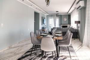 a dining room with a table and chairs at Christinas apartment in Nea Moudania