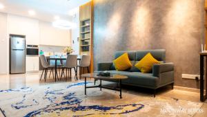 a living room with a couch and a table at Harmony Luxury Suites At TM Persiaran Stonor KLCC in Kuala Lumpur