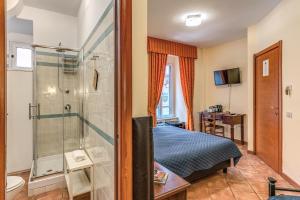 a bedroom with a shower and a bed at Locanda San Cosimato in Rome