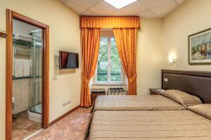 a bedroom with a bed and a shower and a window at Locanda San Cosimato in Rome