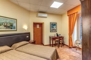 a bedroom with a bed and a desk in it at Locanda San Cosimato in Rome