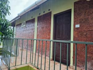 a building with a balcony with a door at Mangrove Ecostay in Gokarna